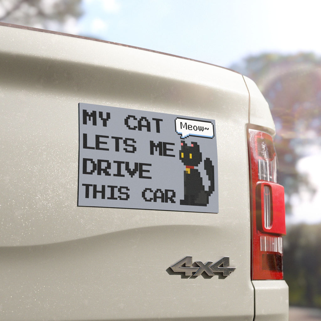 Car sticker with text 'My cat lets me drive this car' on a vehicle's rear
